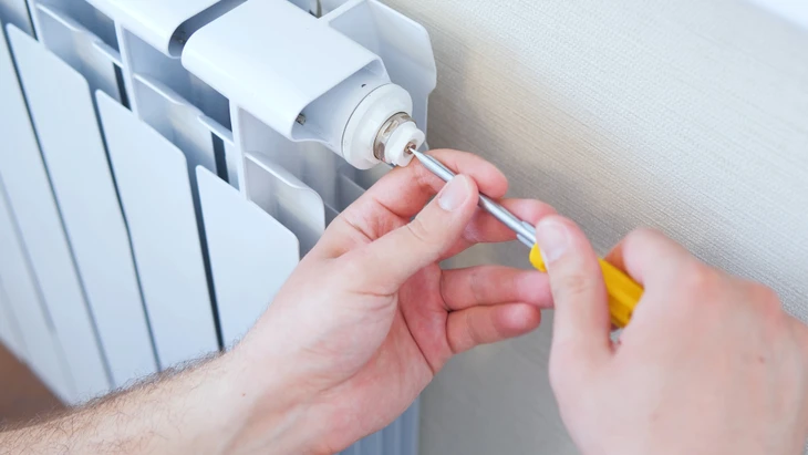 Un technicien de service réparant une cheminée dans une maison